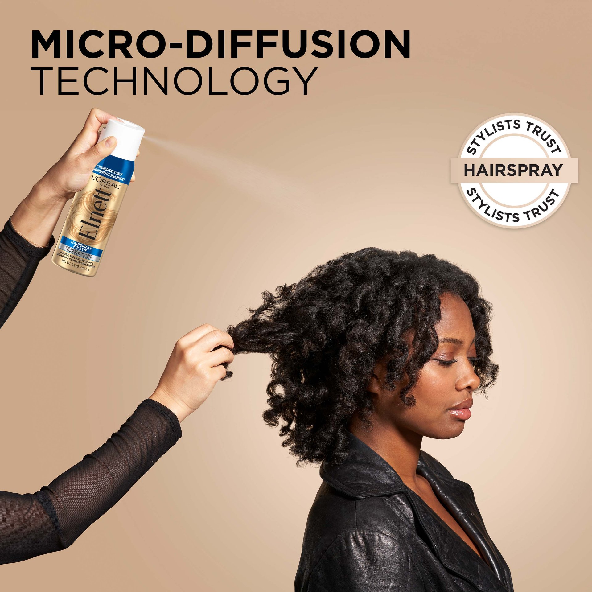 a woman is doing hair care routine and spraying elnett hair spray to fix the blowout